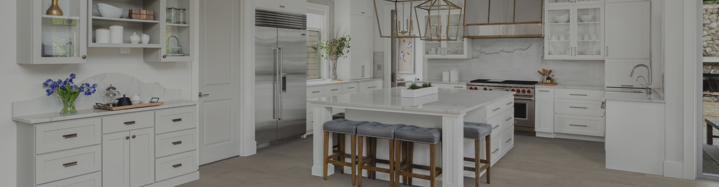 wood-look flooring in a kitchen with white cabinets and countertops